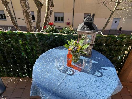 a blue table with a bottle and flowers on it at Casa di Taty B&B in Mestre