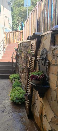 a stone wall with potted plants on it at Dimora Garibaldina in Mentana