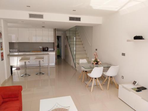 a kitchen and living room with a table and chairs at Marinamed Residential Villa Sea View in Orihuela Costa