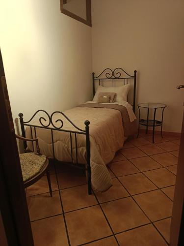 a bedroom with a bed and a table and a chair at Dimora Garibaldina in Mentana