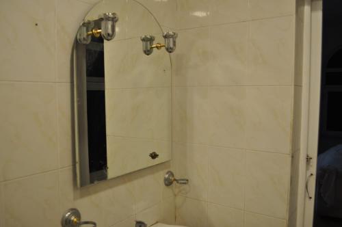 a bathroom with a shower with a mirror at Double Gates Apartment in Baku