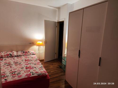 a bedroom with a bed and a dresser and a closet at Altstadt Zimmer in Düsseldorf