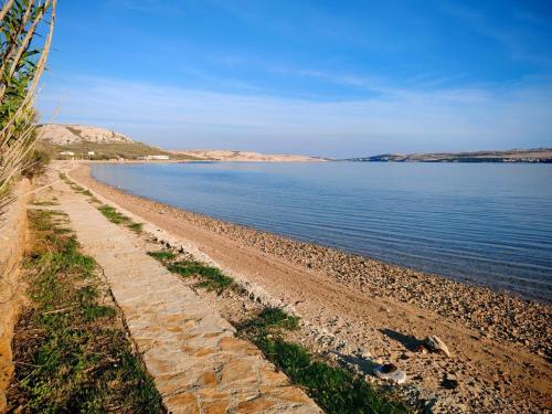 a beach with a rocky shoreline next to the water at Izzi Mobile Home - Terra Park SpiritoS in Kolan