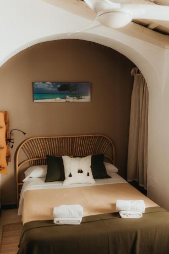 a bedroom with a bed with two towels on it at Hostal Africa in Tarifa