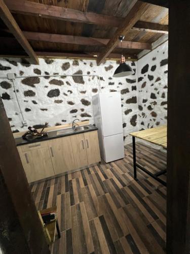 a kitchen with a refrigerator and a table at Casa Rama San Pedro in San Pedro