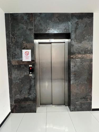 a elevator in a building with a sign on the wall at City Center 1bedroom in Ferizaj