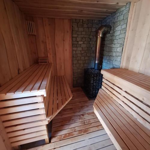 an empty sauna with wooden floors and a stove at Domek w Gruszkach in Gruszki