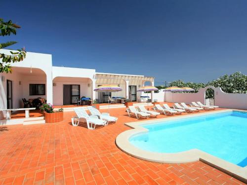 a swimming pool with lounge chairs and a resort at Casa Margarita in Altura