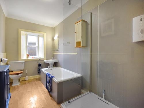 a bathroom with a shower and a sink and a toilet at Rennie House in East Linton