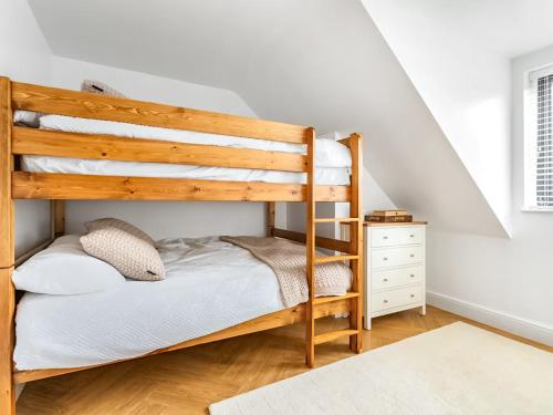 a bedroom with a bunk bed and a staircase at Stargazing in Filby