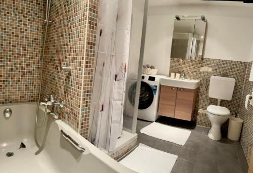 a bathroom with a shower and a toilet and a sink at Apartment by the park, for bike lovers in Alsfeld