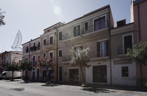 a large building with trees in front of it at Oceano Rooms in Termoli
