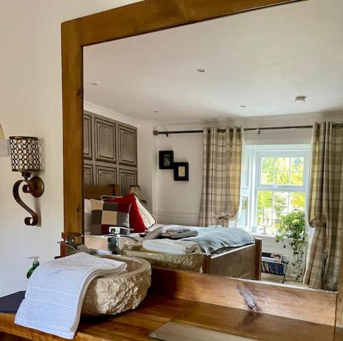 a bedroom with two beds and a large mirror at Lrg Luxury Country Farm House 20 min from the city in Glassford
