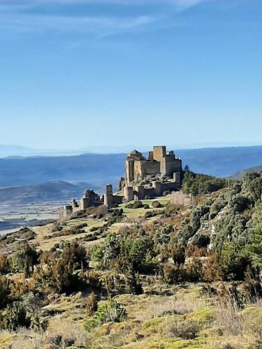 an old castle on top of a hill at Hotel Rural Flor de Almendro in Loarre