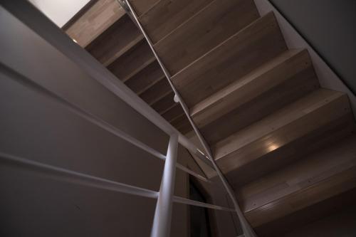 a wooden staircase in a room with a ceiling at Oceano Rooms in Termoli