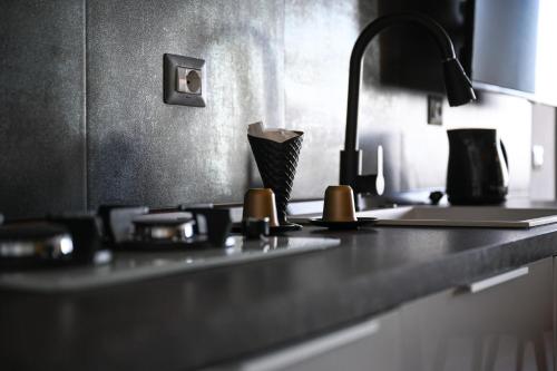 a kitchen counter with a sink and a faucet at Suite 115 - Luxury Rooms in Capoterra