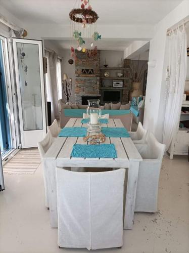 a white table and chairs in a living room at Koundouros Petra house in Koundouros
