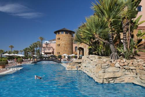 
a large swimming pool in front of a large building at Elba Estepona Gran Hotel & Thalasso Spa in Estepona
