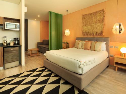 a bedroom with a bed and a living room at Tribu Sonata with pool in Guadalajara