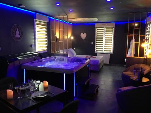 a room with a purple tub in a room with a bed at Lov'Infini in Mers-les-Bains