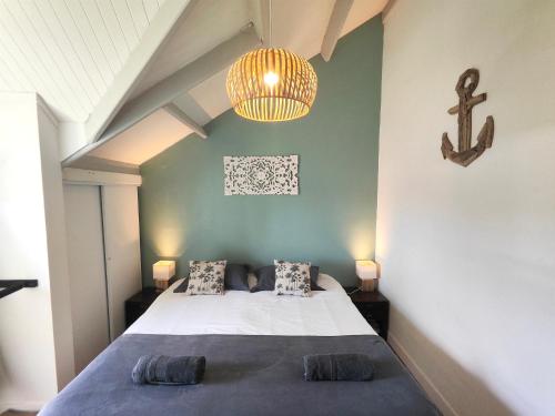 a bedroom with a bed and a cross on the wall at Paradise Duplex avec piscine et accés Plage in Le Gosier