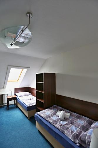 a room with two beds and a room with at Pension & Restaurace Na Rychtě in Prague