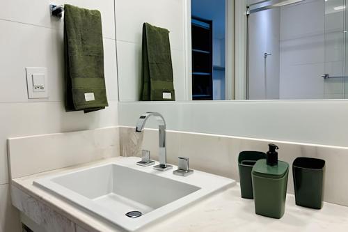 a bathroom with a sink and a mirror at Aptos 2 quartos de Alto Padrão no Solar Tambaú in João Pessoa