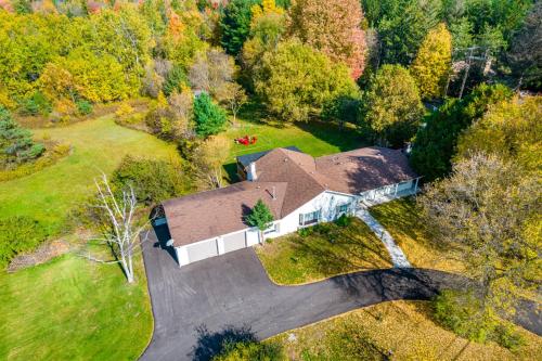 an aerial view of a house in the woods at 5 Bedroom Vacation Cottage - King City in Schomberg