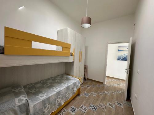 a bedroom with a bunk bed and a staircase at La dolce casa di Sara e Alessia in San Pietro in Bevagna