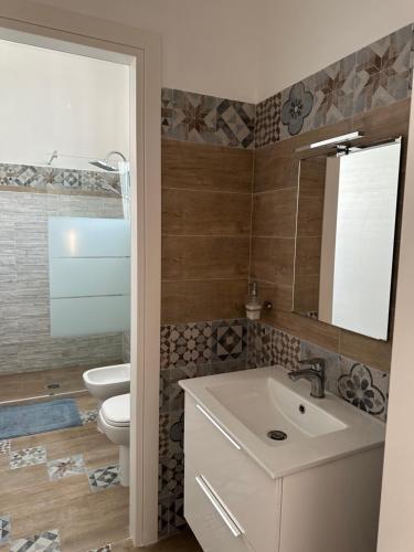 a bathroom with a sink and a toilet at La dolce casa di Sara e Alessia in San Pietro in Bevagna