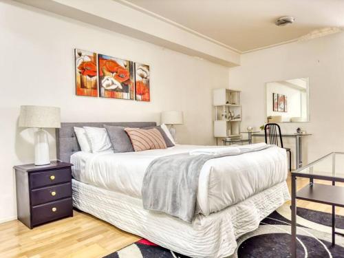 een slaapkamer met een groot wit bed en een tafel bij Superb Apartment in an Heart of Sydney' CBD in Sydney