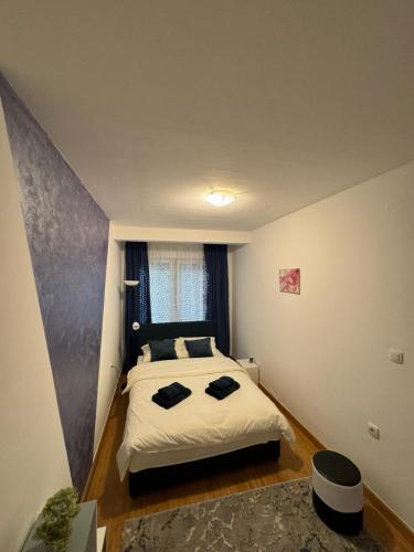 a bedroom with a large bed in a room at Studio29 in Ruma
