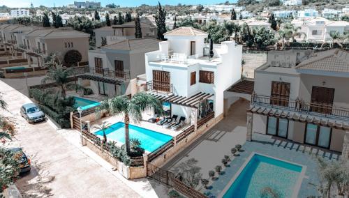 an aerial view of a house with a swimming pool at WealthyStays Sunset Villa, 3min walk to Sea in Paralimni