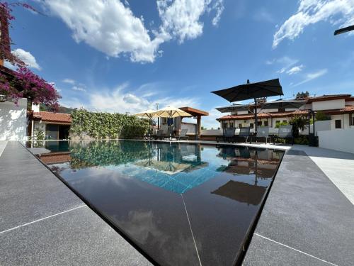 a swimming pool in the middle of a house at Tomsan Suites & Villas Akyaka in Akyaka