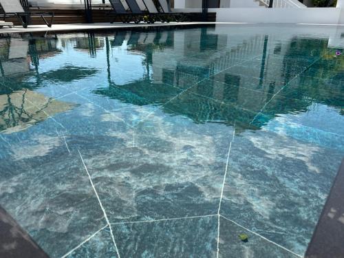 a swimming pool with blue water in a building at Tomsan Suites & Villas Akyaka in Akyaka