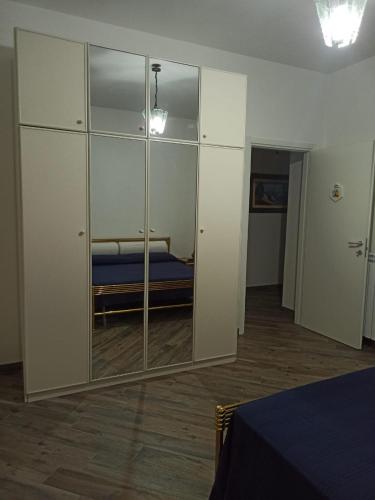 a bedroom with a mirror and a bed in it at B&BEES in Rocca Ranieri