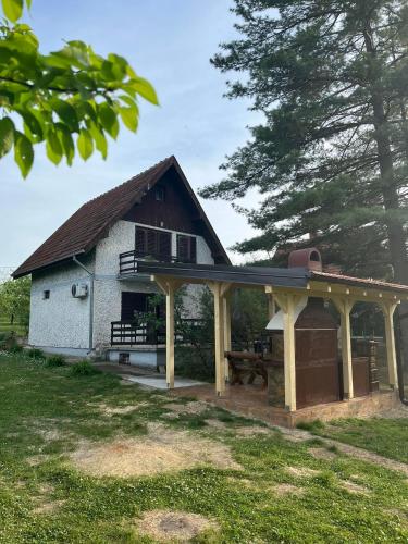 a house with a pavilion with a picnic table at Vikend-kuca Vevericji Kraj in Vranić