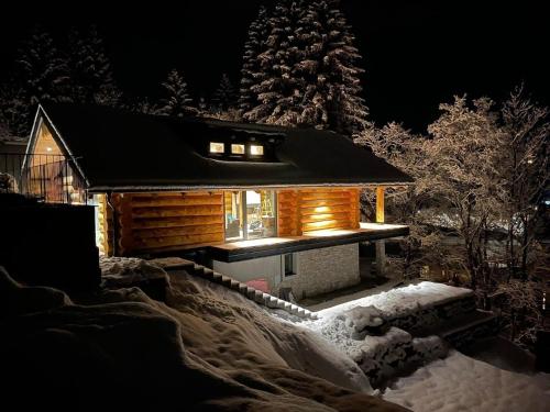 a log cabin in the snow at night at Ferienhaus für 8 Personen ca 200 qm in Bad Kleinkirchheim, Kärnten Oberkärnten in Bach