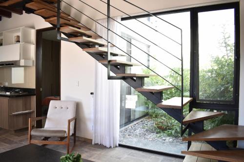 a staircase in a room with a table and a chair at Loft Montenegro in Aguascalientes