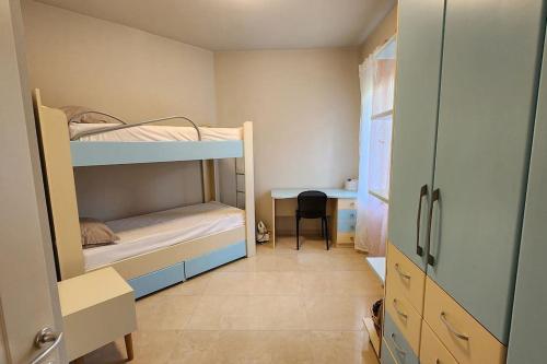 a small room with two bunk beds and a desk at Alba's House Lura1 Residence in Draç