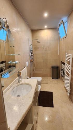 a bathroom with a sink and a toilet at Alba's House Lura1 Residence in Draç