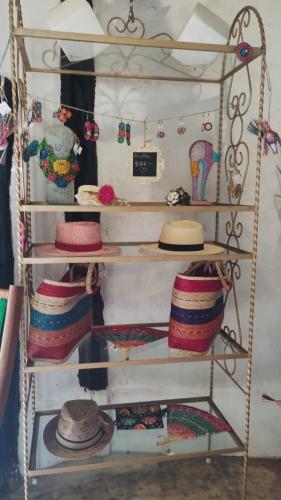 a shelf with hats and other items on it at Hotel y Museo Aldea Maya Toktli Orígenes - Suite La Casa Maya - Alberca, Wifi Starlink, Tour Museo in Izamal