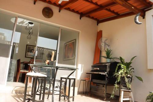 a room with chairs and a table and a mirror at Cozy family home in private condo in Santa Cruz de la Sierra