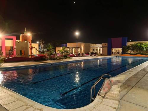 a large swimming pool at night at Cozy family home in private condo in Santa Cruz de la Sierra