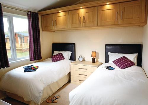 A bed or beds in a room at South Lakeland Leisure Village 