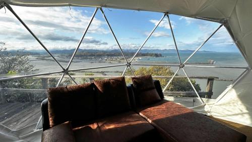 a couch in a tent with a view of the water at Shimanto Yamamizuki - Vacation STAY 36955v in Shimanto