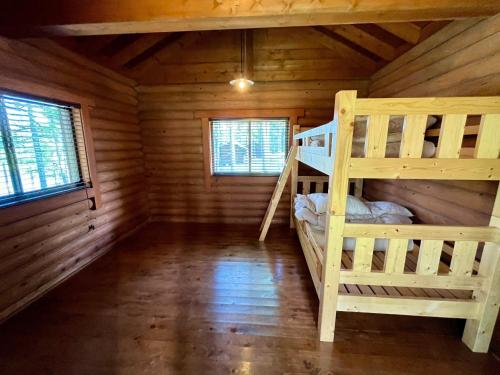 a bedroom with two bunk beds in a log cabin at Nagano Forest Village (former name: Iizuna Kogen C - Vacation STAY 36544v in Nagano