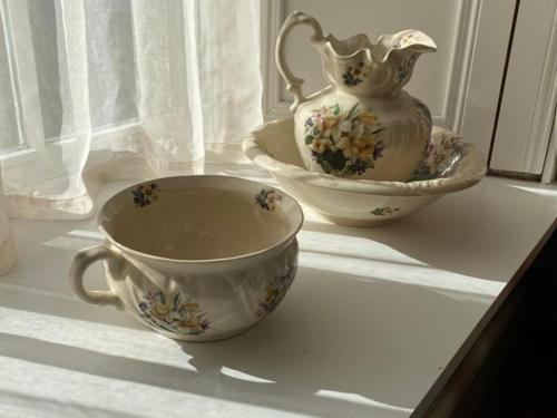 two cups and a vase sitting on a table at Bealkelly Country House in Killaloe