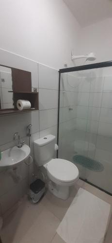 a bathroom with a toilet and a sink at Solaris do Atlantico in Ilhéus