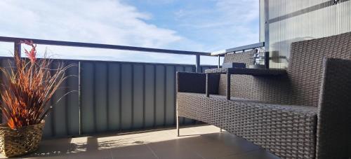 a balcony with a black fence and a plant at Urban Sunset Apartment in Sibiu
